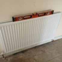 Heating engineer checking a radiator